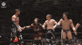 a group of wrestlers are holding hands in a ring with a sign that says ddtpro on it