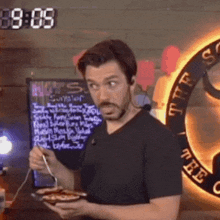 a man is eating a meal in front of a sign that says ' s.s. ' on it