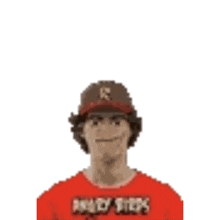 a man wearing a baseball cap and a red shirt is making a face .