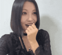 a woman wearing a choker and a black top is making a funny face