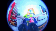 a fisheye lens shows a woman in a green shirt sitting on a couch