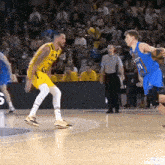 a basketball player wearing a number 11 jersey dribbles the ball