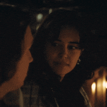 a man and a woman are looking at each other