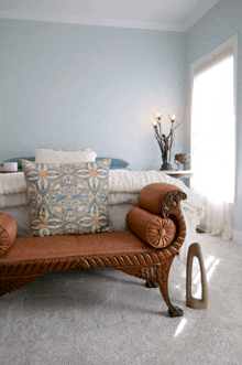 a chaise lounge in a bedroom with a bed and a lamp