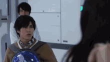a man with a backpack is looking at a woman in a room