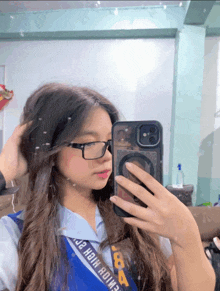 a girl taking a picture of herself with a sash that says jr high home