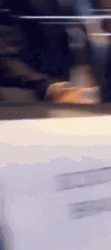 a blurred image of a person 's shadow on a white surface