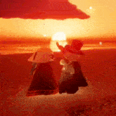 two people are standing on a beach at sunset .