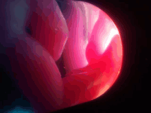 a close up of a red sphere with a dark background
