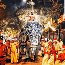 a man riding on the back of an elephant