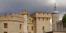 a large castle with a tower and a weather vane on top
