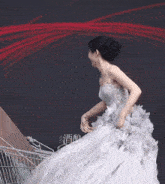 a woman in a white wedding dress is walking next to a shopping cart .