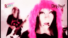 a girl with pink hair is playing a guitar in a band
