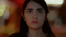 a close up of a woman 's face with a serious expression on her face .