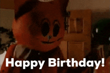 a cat mascot says happy birthday in front of a door