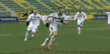 a soccer player in a legends jersey runs on the field