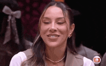 a woman with braces on her teeth is smiling with her eyes closed .