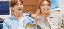 two young men are laughing and one has a name tag that says ' faumi ' on it
