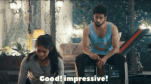 a man sits on a bench next to a woman who is doing exercises and says good impressive