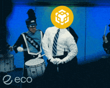 a man in a marching band has a yellow cube on his head and the word eco is on the bottom