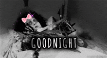 a black and white photo of a woman laying in bed with the words goodnight written on the bottom