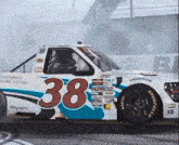 a race car has the number 38 on the side