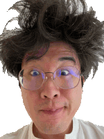 a man with glasses and messy hair makes a face