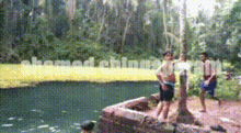 a group of people standing next to a body of water with a watermark that says ' kamed chimney '