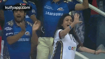 a woman in a samsung shirt is standing next to a man in a samsung shirt