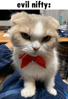 a cat wearing a red bow tie is sitting on someone 's lap and the caption says evil nifty