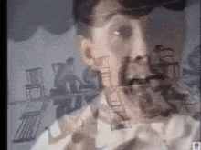 a man 's face is surrounded by chairs in a blurry photo ..