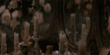 candles are lit in front of a mirror and a bottle of perfume