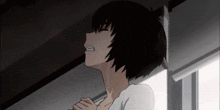 a girl with short black hair is crying with her hands folded