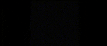 a man with a mustache is wearing a black shirt with the words `` why more ? '' on it .