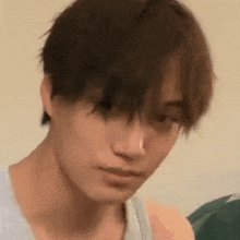 a close up of a person 's face with a serious look on his face .