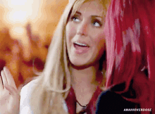 a woman with blonde hair and a woman with red hair are standing next to each other with anahioverdose written on the bottom