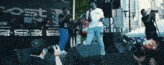 a man taking a picture of a group of people on a stage with a sign that says post
