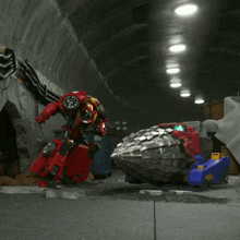 a red toy car is being destroyed by a red robot