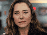 a close up of a woman 's face with a serious expression
