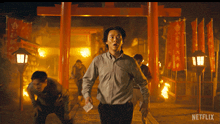 a netflix ad shows a man running in front of a fire