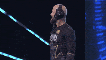 a bald man wearing headphones and a shirt that says ' a few ' on it