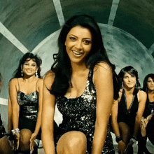 a group of women are posing for a picture and one of them is wearing a sequined top