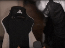 a black and white chair with a playstation logo on the back
