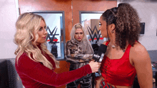 a woman is talking into a microphone that says nxt on it