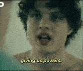 a shirtless man says giving us powers in yellow letters