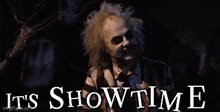 a man in a striped shirt says it 's showtime in front of a graveyard .