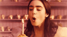 Lily Collins Blowing Candle GIF - Lily Collins Blowing Candle Mirror Mirror GIFs