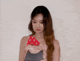 a woman with long hair is wearing a polka dot dress