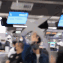 a blurry picture of people on a plane with a blue screen that says ' united ' on it