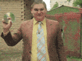 a man in a suit and tie holding a cd